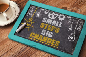 Chalkboard with "Small Steps Big Changes" written on it.