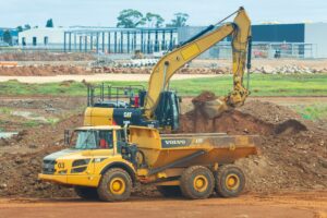 Heavy equipment operating on a construction site, representing the types of businesses that can benefit from Acumatica's specialized solutions.