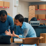 Image of two people managing their supply chain with Acumatica on their laptop.