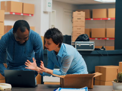 Image of two people managing their supply chain with Acumatica on their laptop.