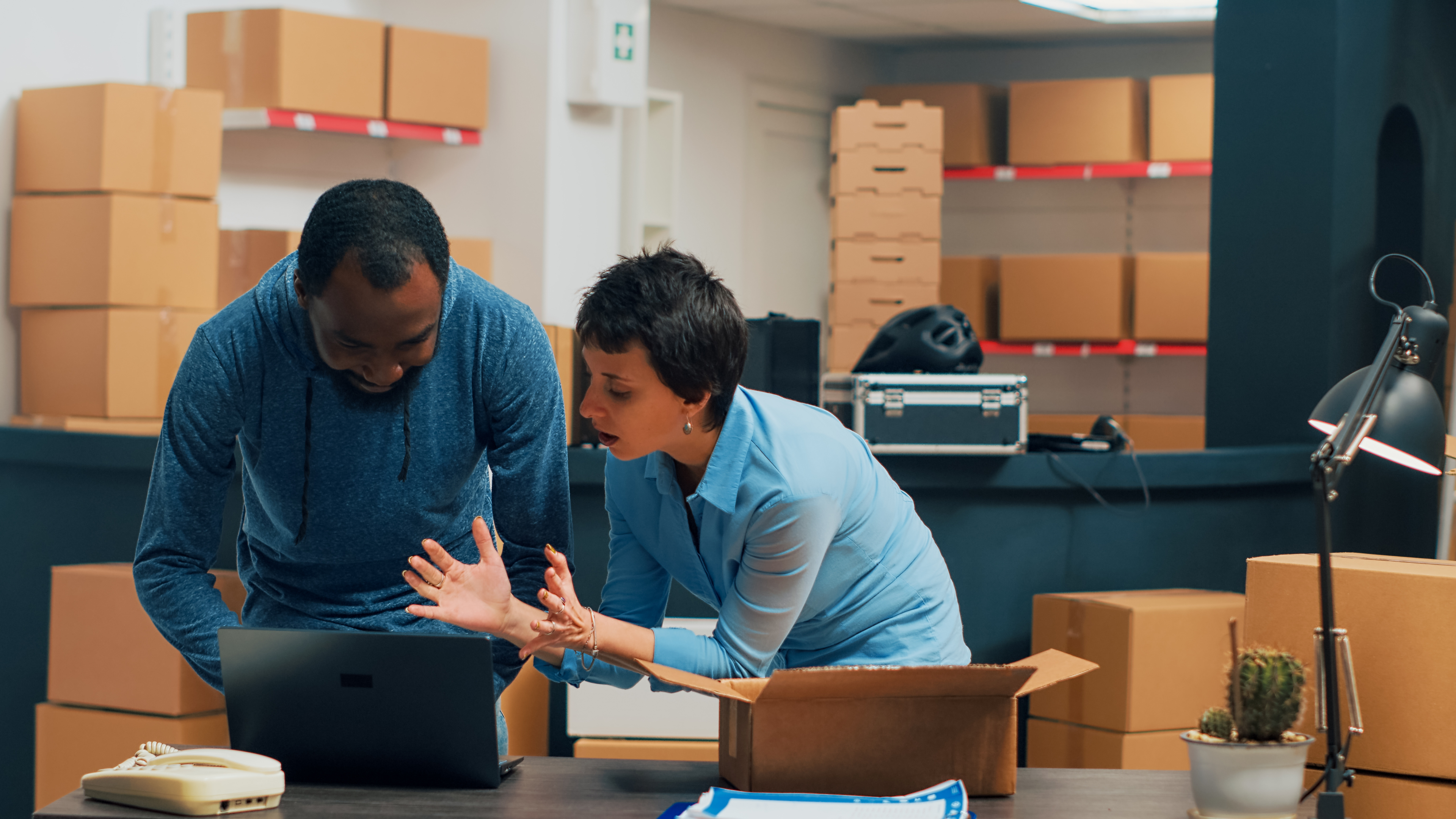 Image of two people managing their supply chain with Acumatica on their laptop.