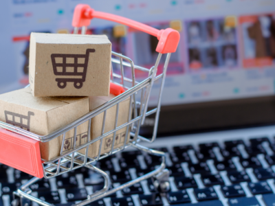 a cart with boxes in it on top of a laptop to represent eCommerce sales.